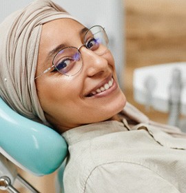 Closeup of patient smiling while sitting in treatment chair