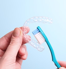 Patient cleaning clear aligner with toothbrush