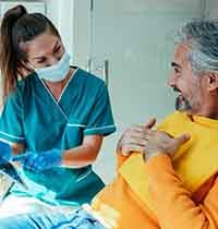 Dental assistant talking to patient about sleep apnea treatment 