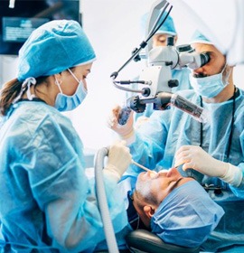 Dental team carefully performing oral surgery