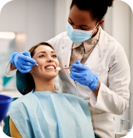 Woman in dental chair having teeth examined