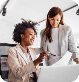 Business woman showing form to another woman in a suit