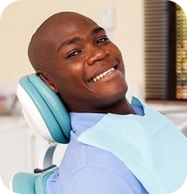Close up of smiling male patient in dental chair