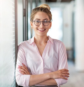 Closeup of woman with glasses smiling in office