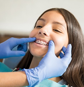 a teenager having their braces examined by an orthodontic braces and Invisalign provider