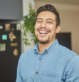 a smiling man with braces