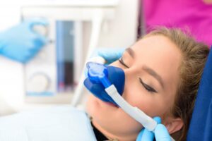 Patient relaxing in dental chair thanks to laughing gas